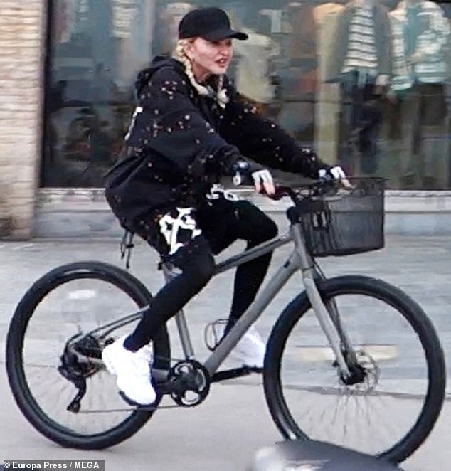 On the Road: As fall progressed and temperatures dropped, Madonna bundled up in a cozy-looking set of sweatshirts and a pair of gloves