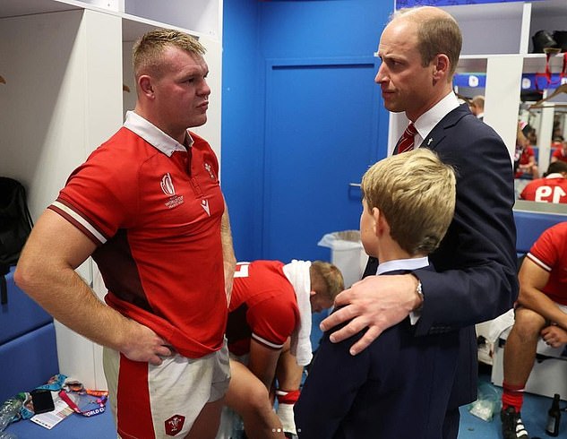Prince William and his son Prince George talk to a Welsh rugby player after the Rugby World Cup quarter-final match between Wales and Argentina on Saturday