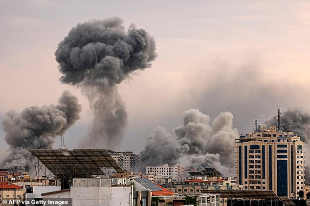 Plumes of smoke rise into the sky of Gaza City on Monday during an Israeli airstrike