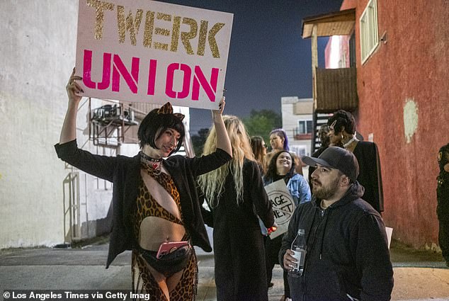 A dancer named Reagan, left, protests outside Star Garden Topless Dive Bar on Saturday, March 26, 2022 in North Hollywood