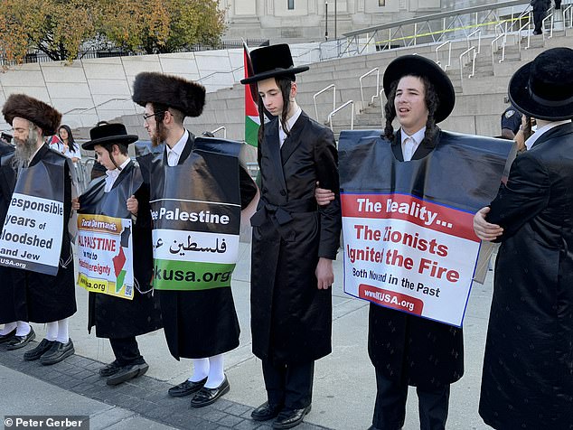 Among the demonstrators were members of the Orthodox Jewish community who carried signs reading 