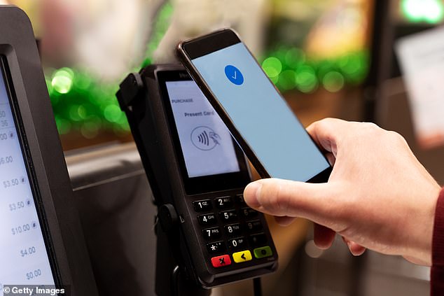 Australia could soon become a cashless society, with a staggering number of bank branches closing in just a year - as hundreds of ATMs would also be removed (pictured is a digital tap-and-go reader)