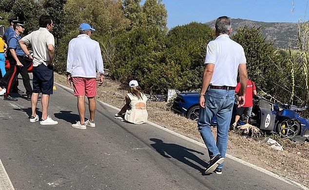 Joshi is pictured sitting on the side of the road, with reports claiming she cried as she viewed the wreckage of their car in the aftermath of the crash.