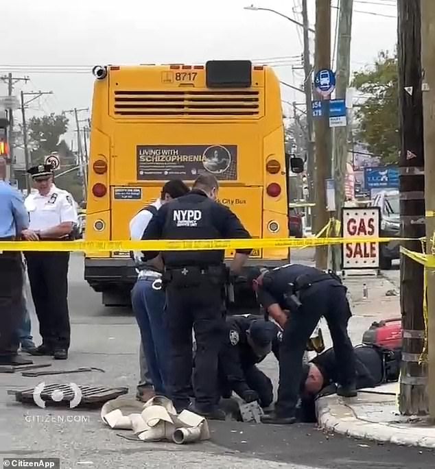 Investigators were pictured at the scene searching for the knife used in the attack, even through a storm drain directly behind the parked bus.