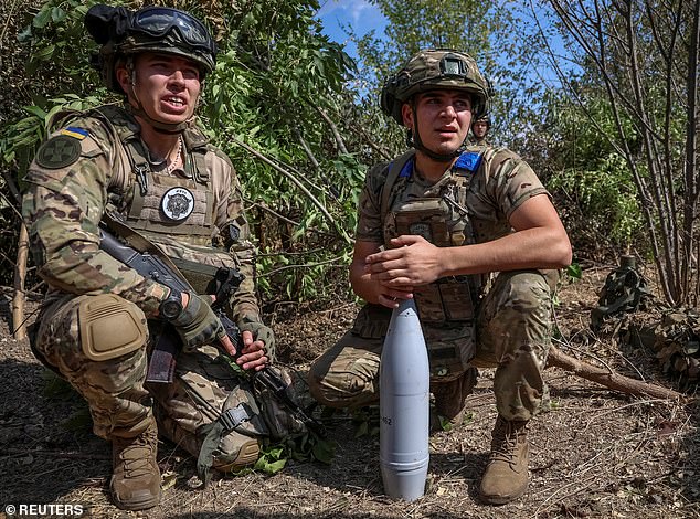 Ukrainian soldiers of the Spartan Brigade of the National Guard of Ukraine prepare a grenade for a D-30 howitzer at a frontline position, amid the Russian attack on Ukraine, in the Zaporizhia region, Ukraine, September 13