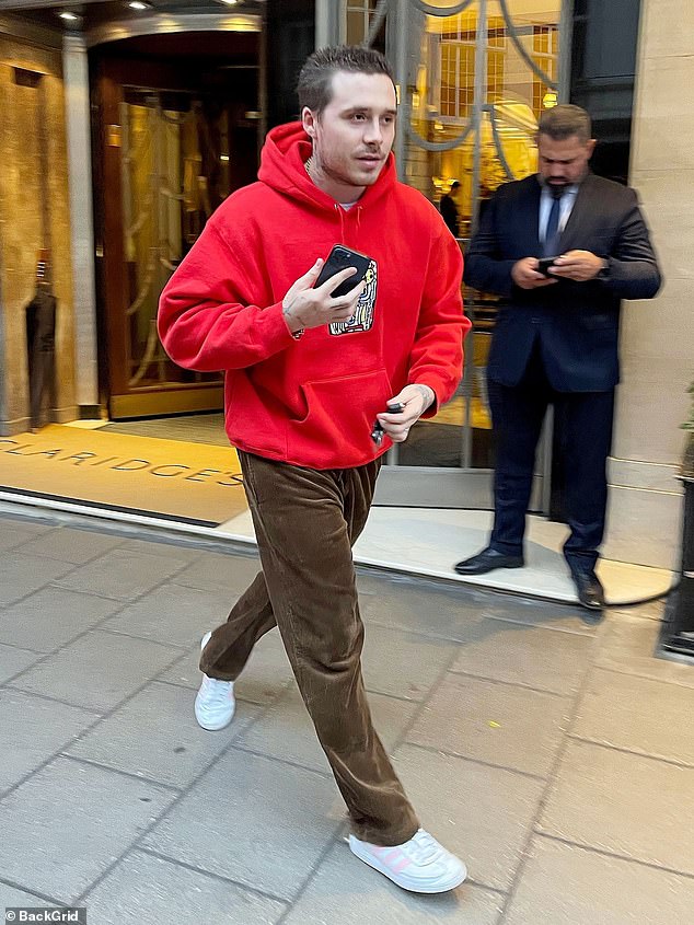 Out and about: Brooklyn Beckham, 24, and his wife Nicola Peltz arrived at a London hotel on Wednesday with their pet dogs