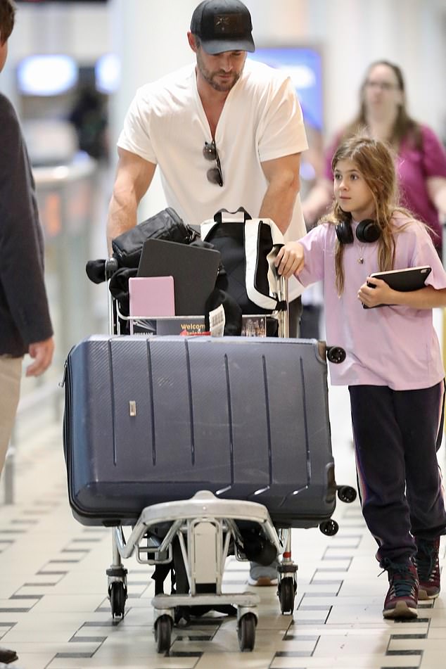 The Hollywood megastar casually wore a white T-shirt and comfortable black pants as he pushed a trolley full of luggage through the airport