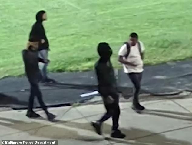 A short video released by police shows four men walking in a grassy area of ​​the campus prior to the shooting