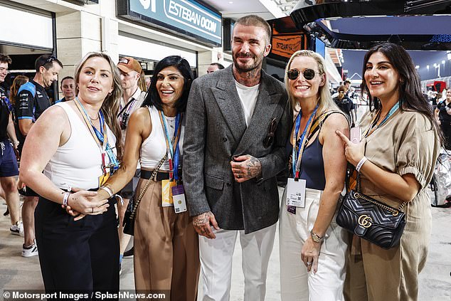 David Beckham, 48, beamed as he joined a group of female fans for a photo at the Lusail International Circuit ahead of the Formula 1 Qatar Grand Prix