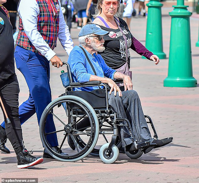 Legend: Dick Van Dyke, 97, was pushed into a wheelchair while enjoying a day out at Disneyland in Anaheim, California, with his wife Arlene Silver, 52, on Monday