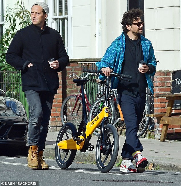 Long-time pals: They were seen drinking coffee as they strolled down the street, with Dominic wearing a bright blue jacket and Stephen looking smart in a black tailored coat