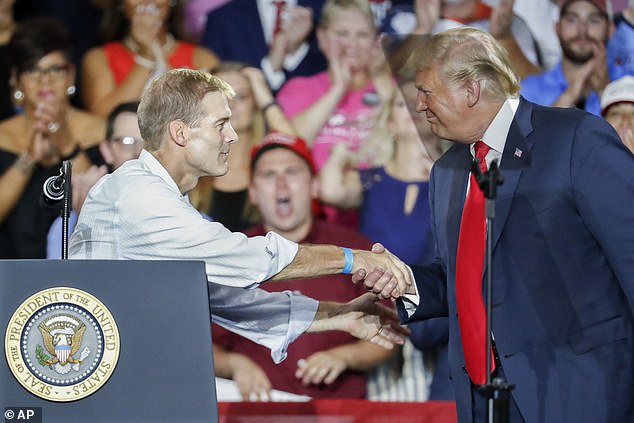 Donald Trump shakes hands with Rep. Jim Jordan during a rally in Ohio in August 2018