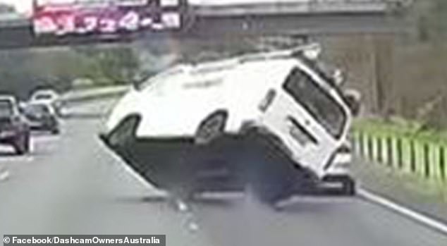 The dramatic moment a van swerved before overturning (pictured) on the northern Hume highway just before midday on Monday was captured by dashcam footage