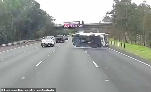 As the van swerved for a second time before hitting the rear of another vehicle in the right country and flipping onto its side (pictured)