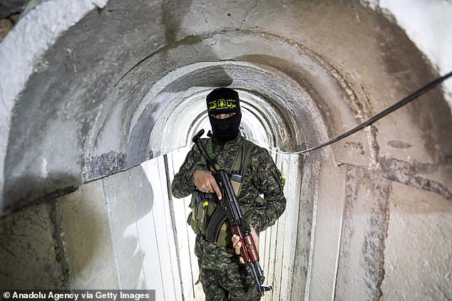 A member of the Al-Quds Brigades, an armed wing of the Islamic Jihad movement, stands guard in a tunnel on the Israel-Gaza border on March 30, 2023.