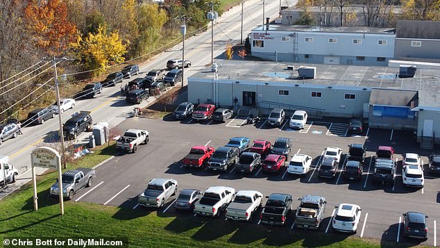 Vehicles of those who enjoyed a night out at Schemengees Bar & Grill in Lewiston are parked amid the ongoing crime scene investigation