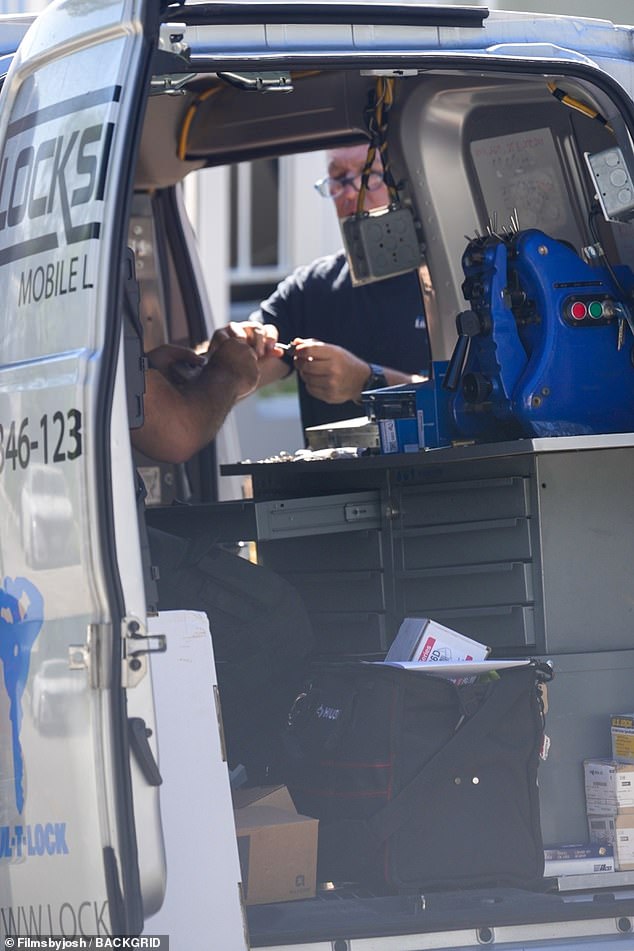 Locksmiths are seen Thursday at the Brentwood home where the 'tenant from hell', squatter Elizabeth Hirschhorn, refuses to leave