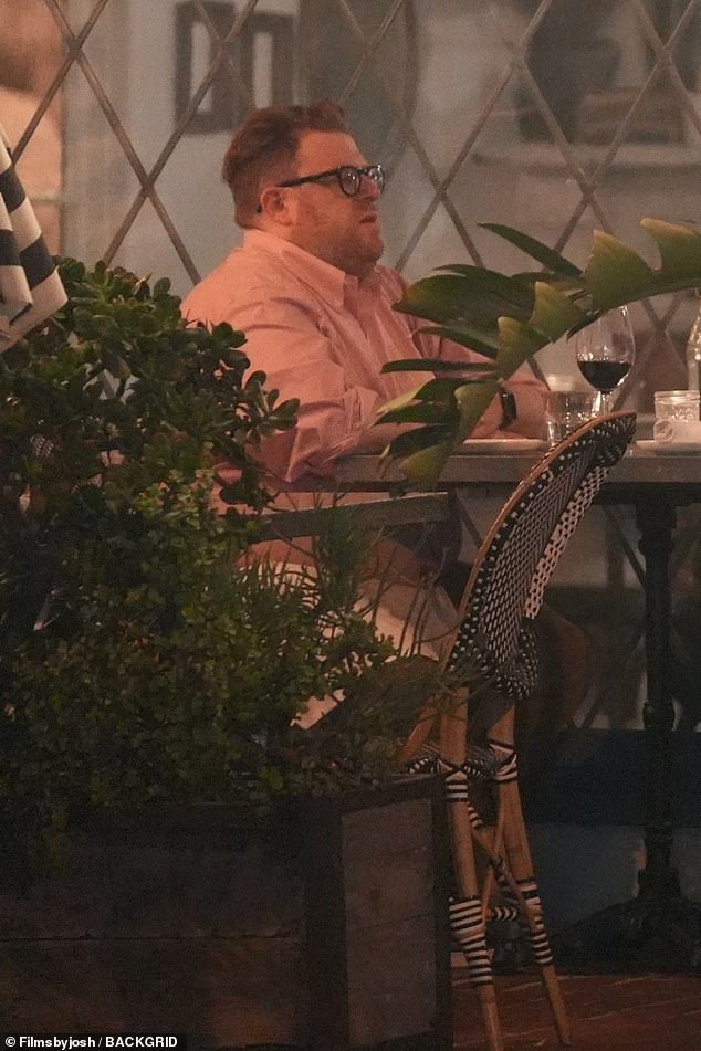 The 55-year-old was spotted sitting across from her date, who wore a salmon pink shirt, khaki pants and stylish black glasses