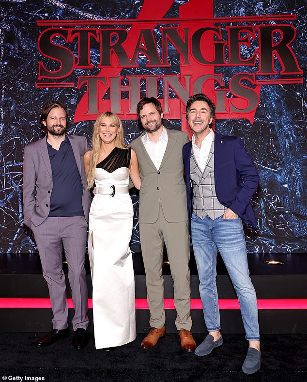 The British star pictured in 2022 with Stranger Things creators Matt and Ross Duffer and show executive producer Shawn Levy (right)