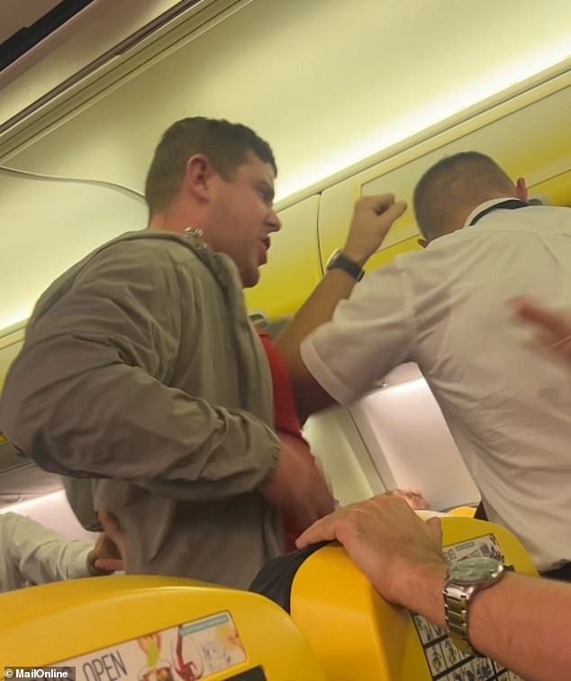 The man is seen punching one of the cabin crew members on board the flight from Manchester to Dublin