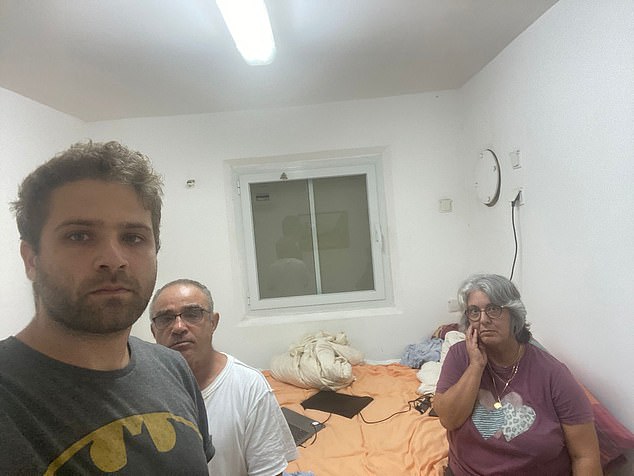 Israeli medical student Bar Mizrachi (left), pictured with his parents in a safe room in their kibbutz