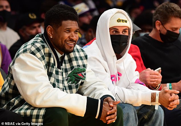 Usher, pictured with Justin Bieber at a 2021 basketball game, reportedly threw a few ideas at his former mentee for his Super Bowl halftime show