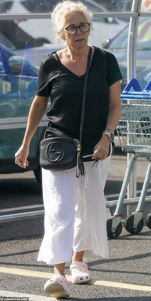 Dejected: Lucy Benjamin, 53, looked glum when she was first spotted without a wedding ring on September 14.  Two weeks after her divorce from Richard Taggart was reported