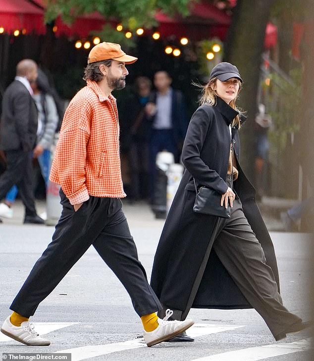 Couple: Elizabeth Olsen (34) and her husband Robbie Arnett were spotted on a casual stroll in New York City on Thursday.  She looked chic in a long black coat