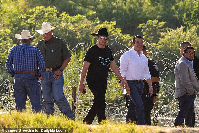 Musk (center) is seen Thursday with Eagle Pass Mayor Rolando Salinas in a white shirt