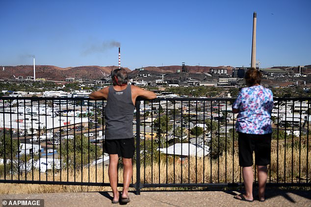 Locals enjoy the view of the Mount Isa mines, which will close in 2025