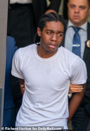 Teenage suspect Brian Dowling, 18, is marched out of the 81st Precinct in Bedford Stuyvesant in tears Thursday after his arrest