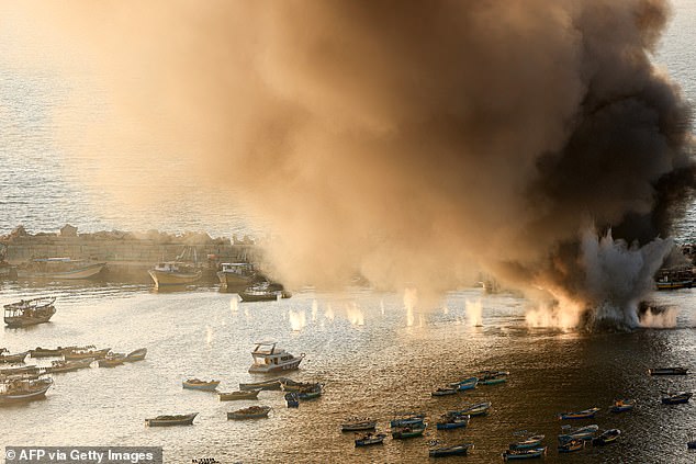 Smoke billows after a strike by Israel on the port of Gaza City on Tuesday.  Economists are watching the conflict closely to see how it affects global trade and commodities