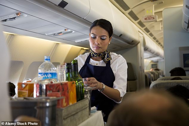 Flight attendants have shared some things they've done on board planes that might come as a surprise to regular fliers.  Pictured: A cabin crew member offering passengers drinks (File Image)