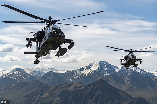 Helicopters fly over a mountain range near Fort Wainwright, Alaska