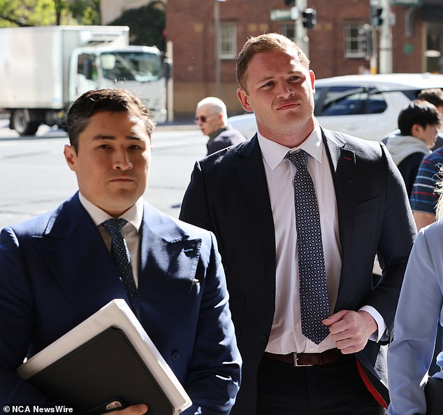 Burgess (right, pictured in court with his lawyer Bryan Screw on Monday) has pleaded not guilty to a charge of sexual touching without consent.