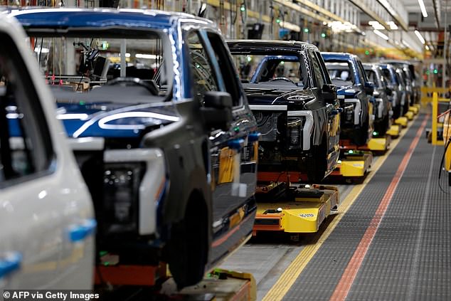 Ford will cut about 700 workers involved in the assembly of the F-150 Lightning, an electric variant of the company's best-selling pickup.  Pictured is Ford Motor Company's electric F-150 Lightning on the production line at their Rouge Electric Vehicle Center in Dearborn, Michigan