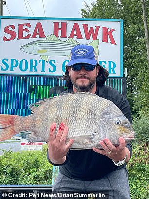 Brian Summerlin, 38, holds the record-breaking fish