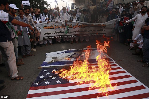 Dramatic images of the US and Israeli flags engulfed in flames have emerged around the world as Hamas terrorists launch a brutal attack on Israel