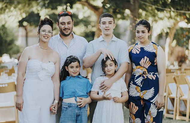 The pair were only rescued after the Israel Defense Force (IDF) bombed the house, their neighbor Golan Abitol revealed (photo from left to right: Hagit and Golan Abitol, with son Yoav and daughter Libi and twins Keren and Ziv in front)