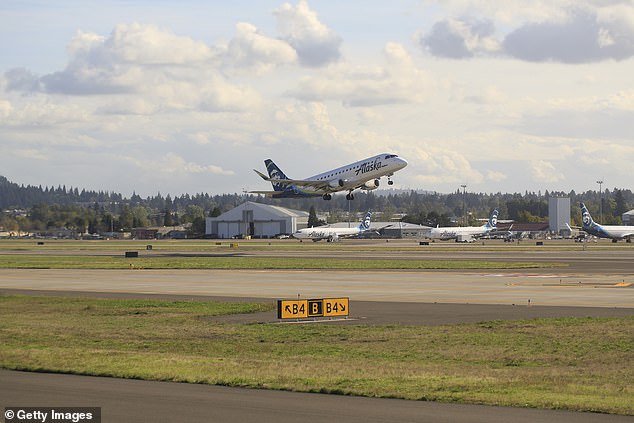 Pilots aboard an Alaska Airlines regional jet diverted their flight to Portland after someone reportedly cleared to ride in the cockpit tried to shut down the engines.  (Pictured: An Alaska Airlines plane at the same airport in 2020)