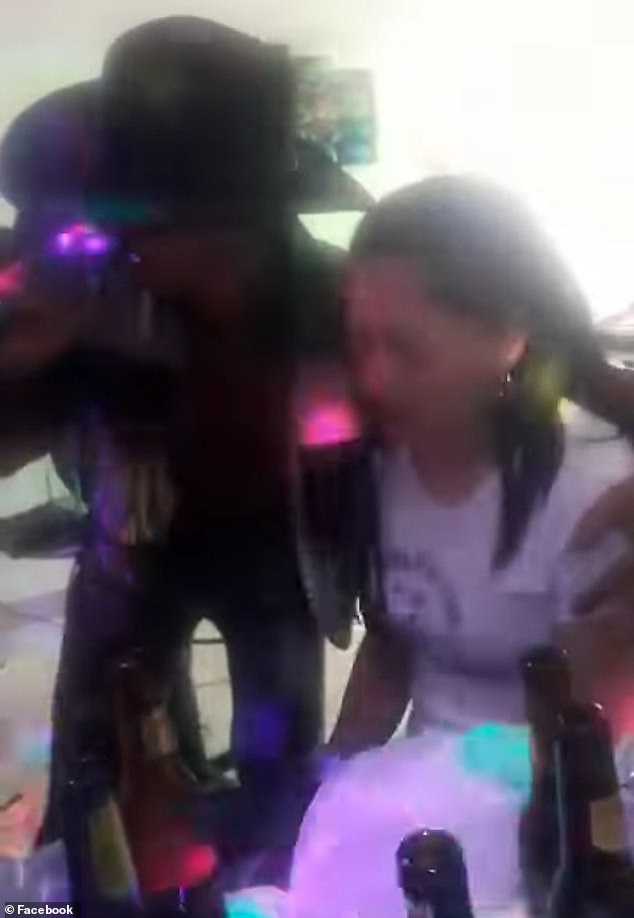 Luis Mendivelso (left) hugs a woman (right) as he sang to her at a bar in Bogotá, Colombia on Sunday before her boyfriend, Miguel Rangel, assaulted him and left the bar before returning with two men and stabbed him.  The 47-year-old married father of five was rushed to a hospital, where he died