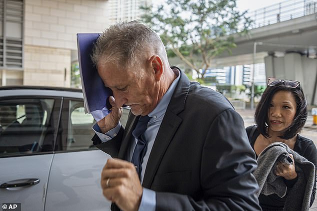 Washington state Sen. Jeff Wilson hesitated to face photographers as he arrived at a Hong Kong courthouse to hear a verdict that could have seen him serve 14 years in prison for bringing an unlicensed gun into the repressive former colony