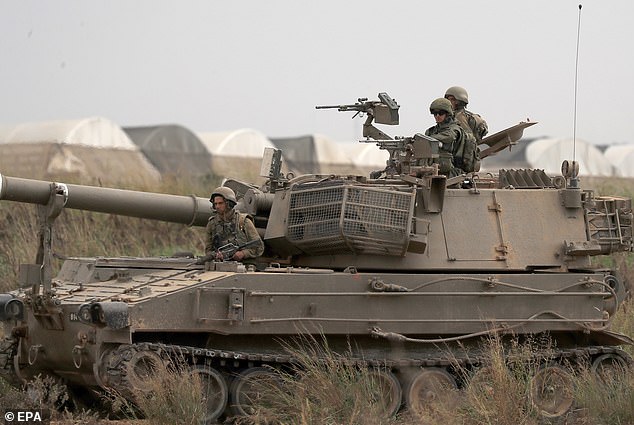 Israeli soldiers in military vehicles maneuver in an area along the Gaza border in southern Israel on Monday