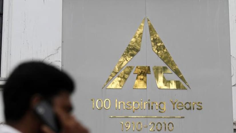 A man talks on his mobile phone as he walks past an ITC office building in Calcutta.  Photo: Reuters