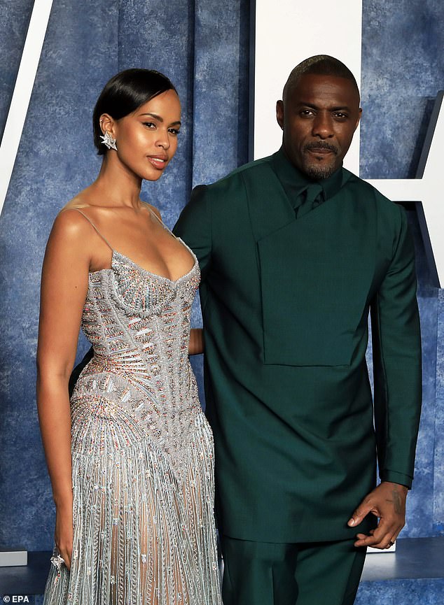 Candid: Idris Elba admitted he started seeing a therapist a year ago because he's an 'absolute workaholic' – (pictured with wife Sabrina in March)