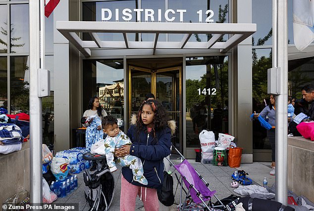 A family from Venezuela outside the Chicago 12th District police station