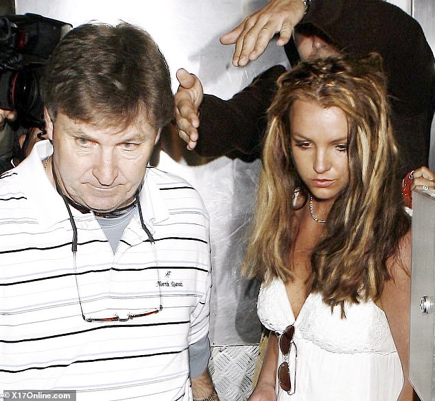 hard read: Britney Spears has recalled her harrowing childhood and teenage years in her new memoir, The Woman In Me (pictured with her father Jamie in 2008)