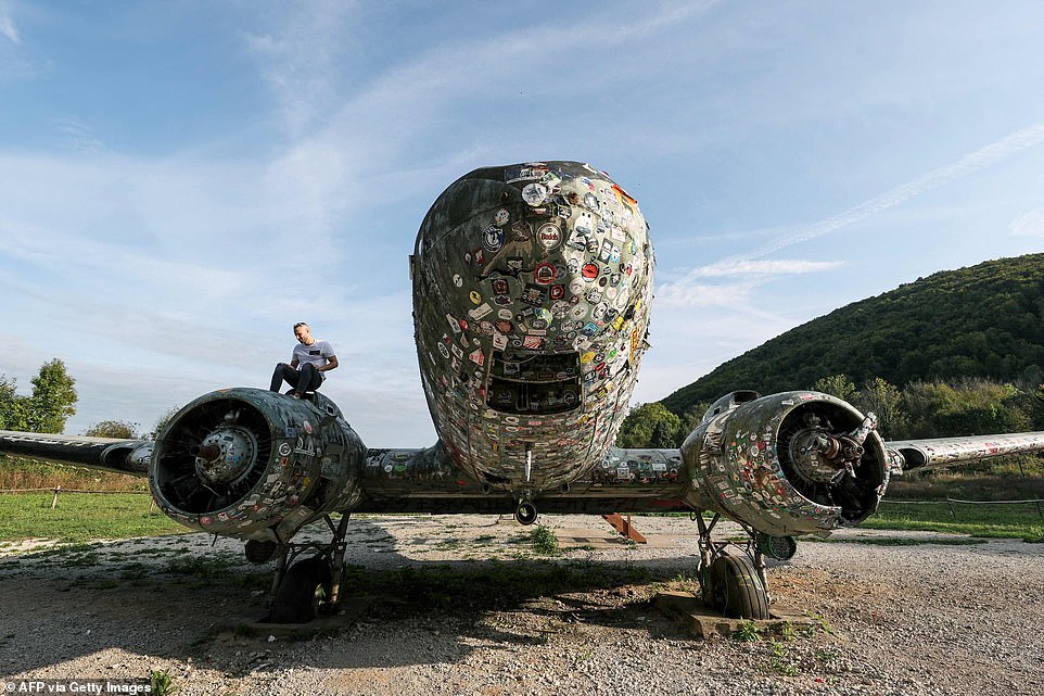 This photo, taken on October 4, 2023, shows the Douglas C-47 B Dakota US Army aircraft covered with stickers at the Zeljava underground army airbase in the heart of Pljesevica Mountain, on Croatia's border with Bosnia