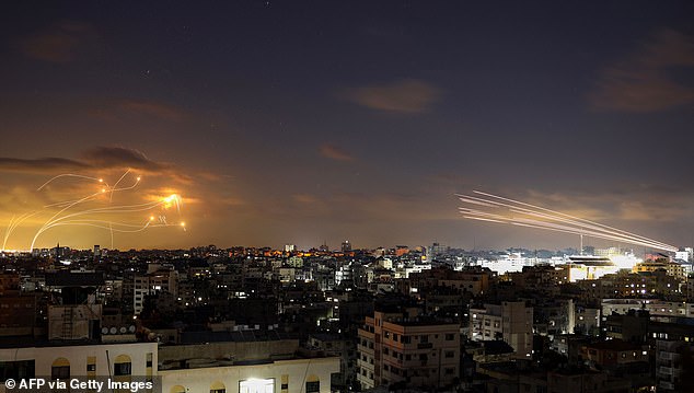 Rockets fired from Gaza City (R) are intercepted by Israel's Iron Dome missile defense system (L) on Tuesday