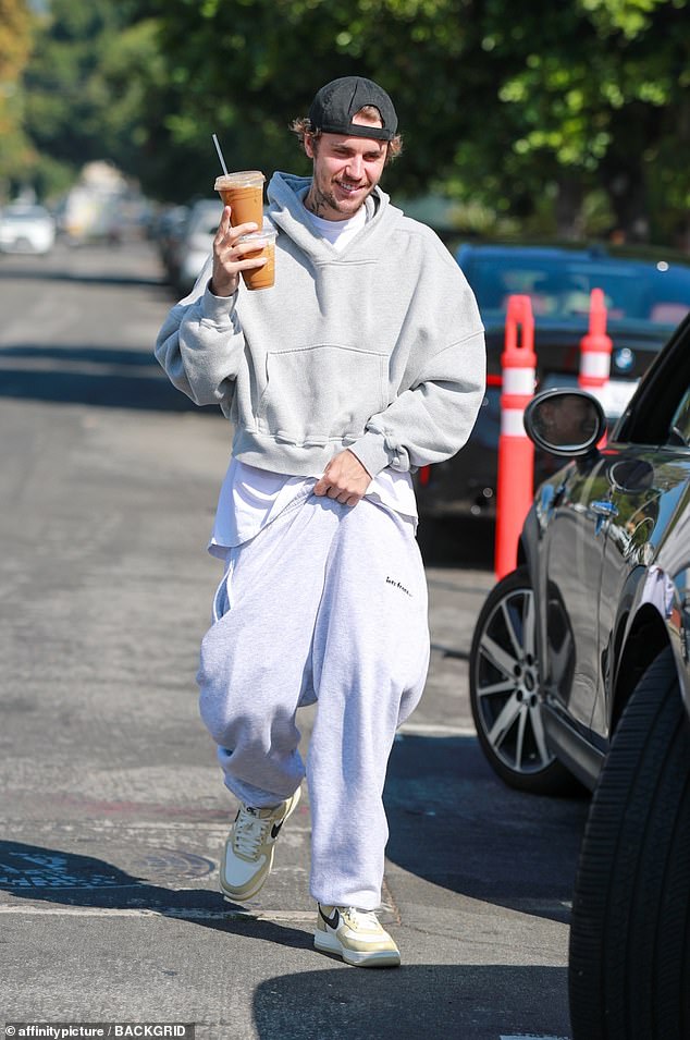 Getting caffeinated: Justin Bieber was spotted having a solo coffee in Los Angeles on Tuesday morning.  The 29-year-old singer put on a relaxed display and worked up a sweat as he grabbed two cups of iced coffee from Community Goods Coffee in West Hollywood